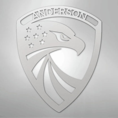 Silver metal shield art with an eagle head, stars, and "ANDERSON" at the top.