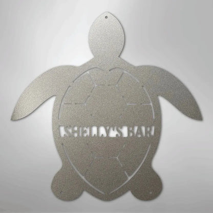 Silver metal turtle wall art with "SHELLY'S BAR" cut out of its shell.