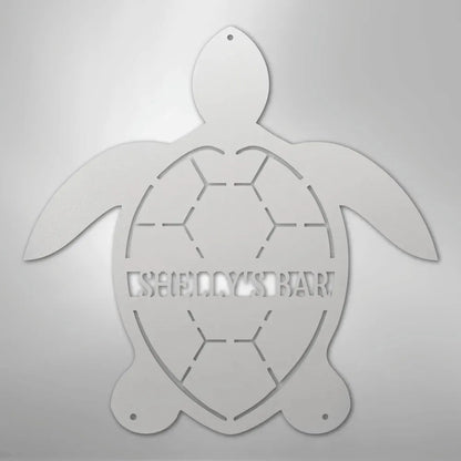 White metal turtle wall art with "SHELLY'S BAR" cut out of the shell.