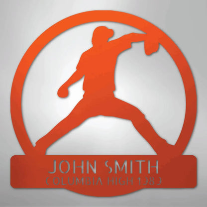 Orange metal wall art with a baseball pitcher silhouette in a circle, personalized with "JOHN SMITH" and "COLUMBIA HIGH 1989".