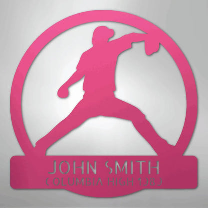Pink metal wall art featuring a baseball pitcher silhouette within a circle, personalized with "JOHN SMITH" and "COLUMBIA HIGH 1283".