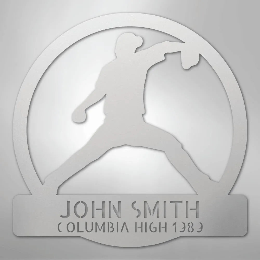 Silver metal wall art with a baseball pitcher silhouette in a circle, personalized with "JOHN SMITH" and "COLUMBIA HIGH 1983".