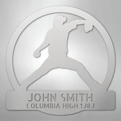 Silver metal wall art with a baseball pitcher silhouette in a circle, personalized with "JOHN SMITH" and "COLUMBIA HIGH 1983".