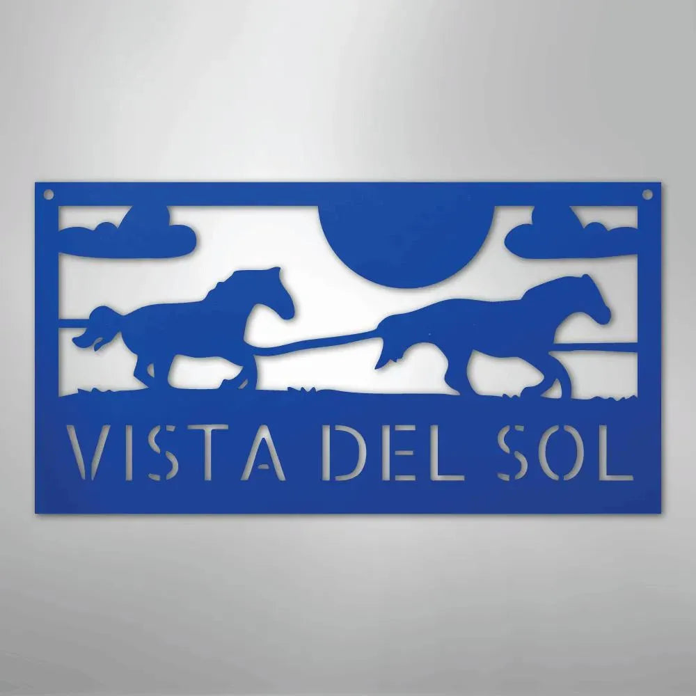 Blue metal sign with two racing horses, clouds, sun, and "VISTA DEL SOL" text.