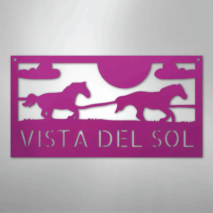 Pink metal sign with two racing horses, sun, clouds, and "VISTA DEL SOL" text.