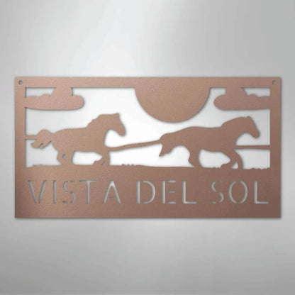 Copper-toned metal sign with two racing horses, sun, clouds, and "VISTA DEL SOL" cut out.