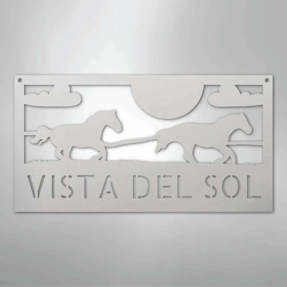 White metal address sign with two racing horses, sun, clouds, and "VISTA DEL SOL" text.