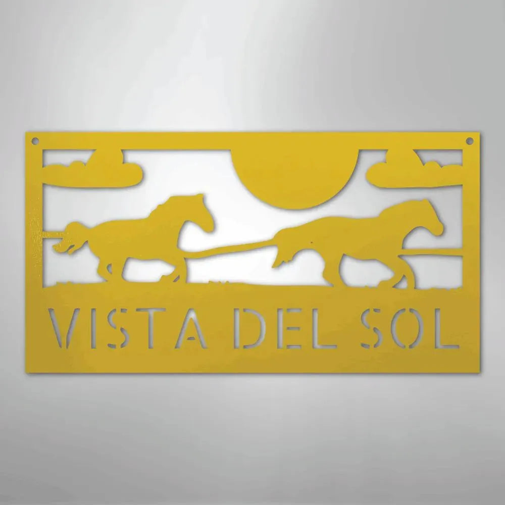 Yellow metal sign with two racing horses, sun, clouds, and "VISTA DEL SOL" cut out.