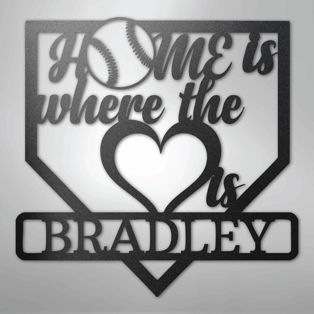 Black metal baseball home plate sign with "Home is where the heart is" and "Bradley" text.