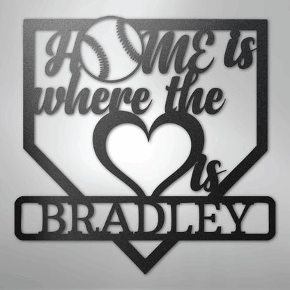 Black metal baseball home plate sign with "Home is where the heart is" and "Bradley" text.