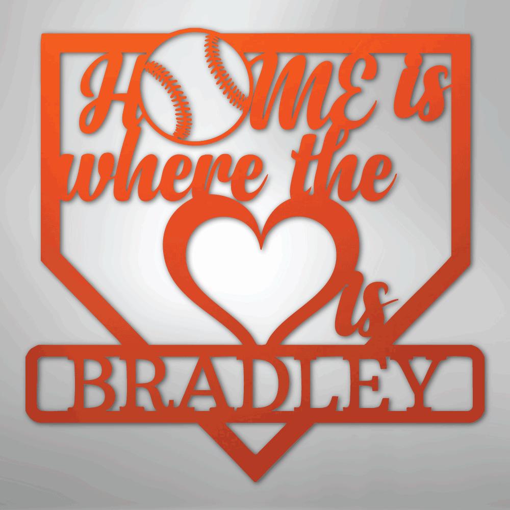 Orange metal baseball home plate sign with "Home is where the heart is Bradley" text and a baseball.