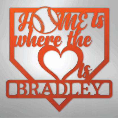 Orange metal baseball home plate sign with "Home is where the heart is Bradley" text and a baseball.