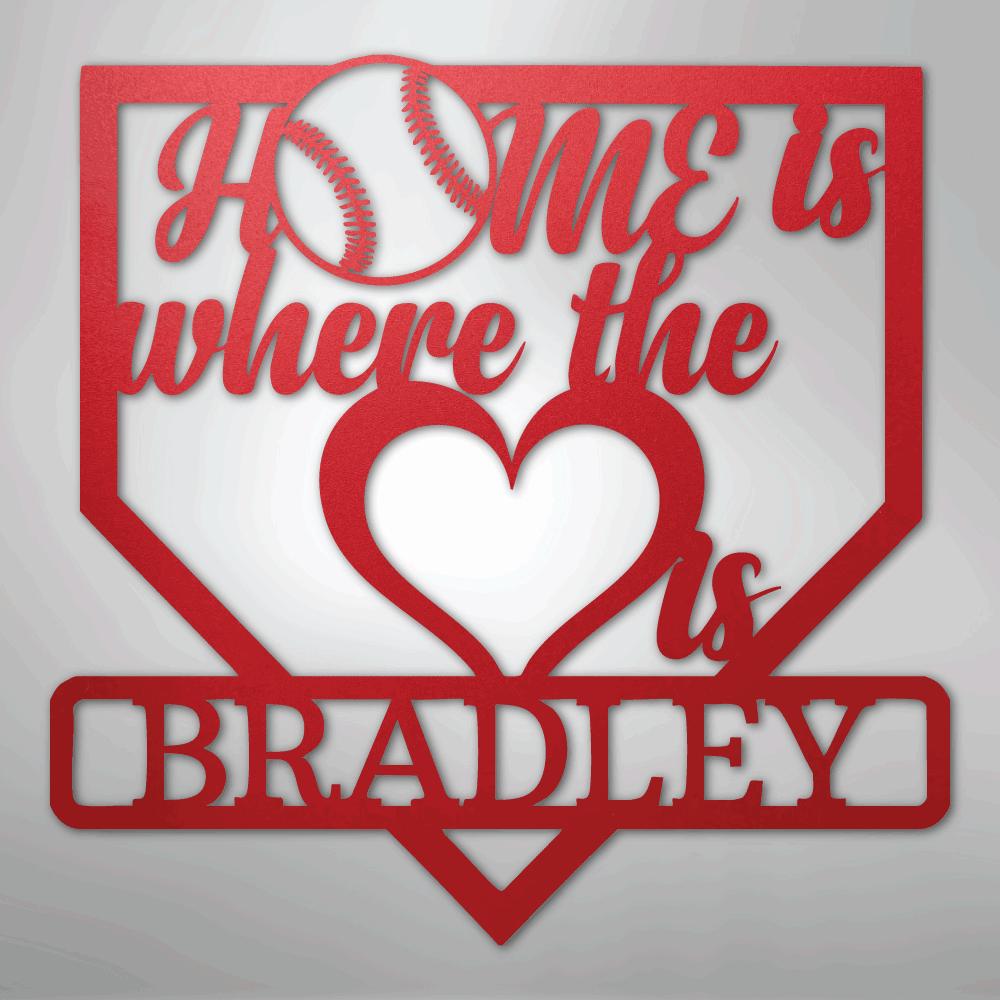 Red metal baseball home plate sign with "Home is where the heart is" and "Bradley" text.