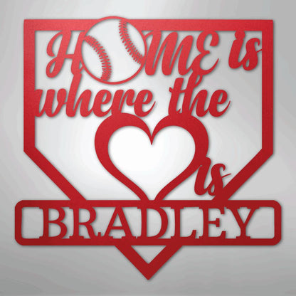 Red metal baseball home plate sign with "Home is where the heart is" and "Bradley" text.