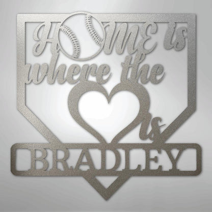 Silver metal baseball home plate sign with "Home is where the heart is Bradley" text and baseball graphic.