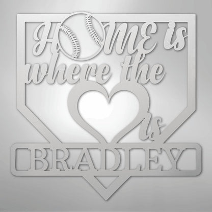White metal baseball home plate sign with "Home is where the heart is" and "BRADLEY" cut out.