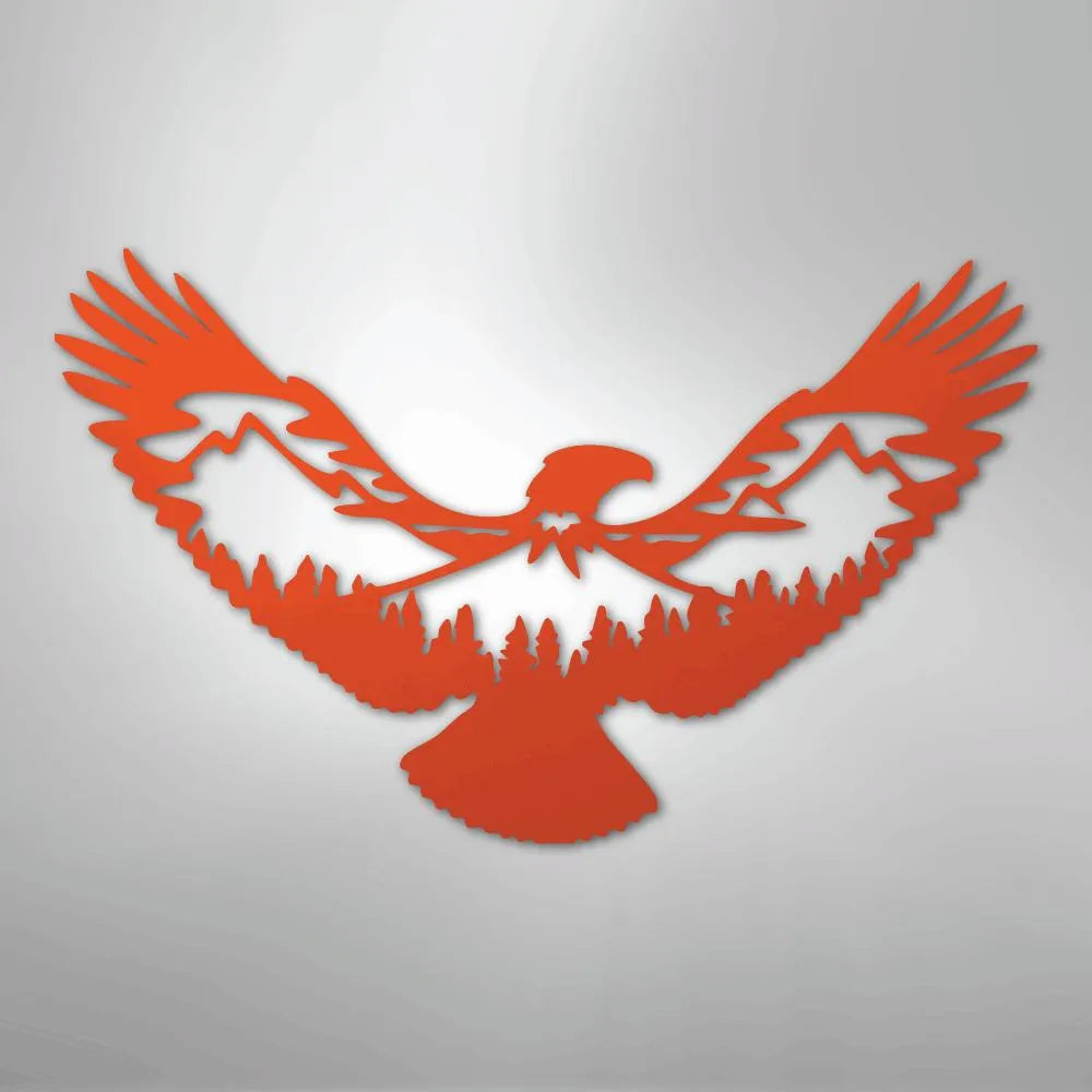Orange metal wall art of an eagle with mountain and forest silhouette cutouts.