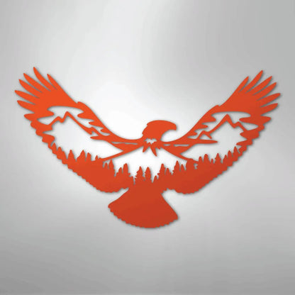 Orange metal wall art of an eagle with mountain and forest silhouette cutouts.