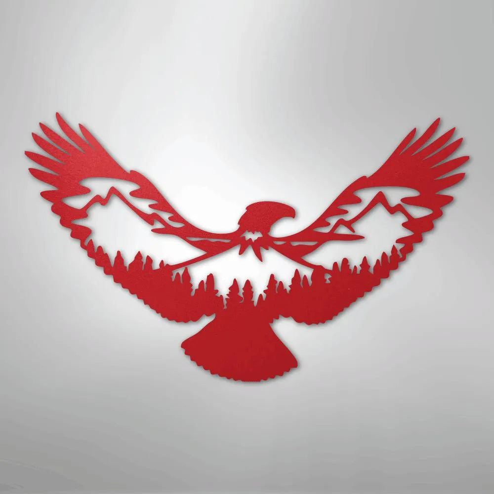 Red metal wall art featuring an eagle silhouette with mountains and pine trees cut out of its wings and body.