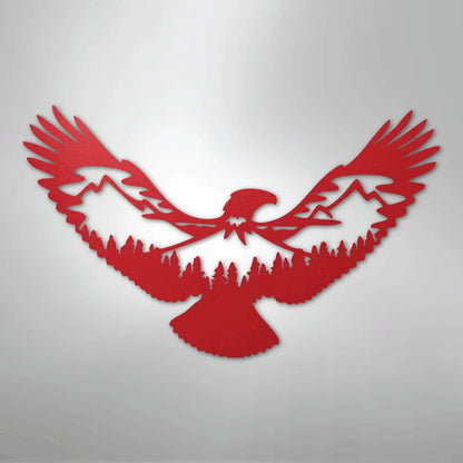Red metal wall art featuring an eagle silhouette with mountains and pine trees cut out of its wings and body.