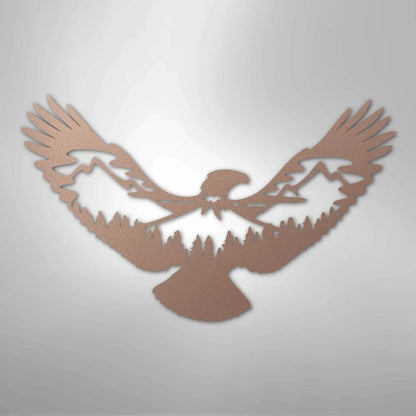 Copper metal wall art of an eagle with mountains and pine trees silhouetted in its wings.
