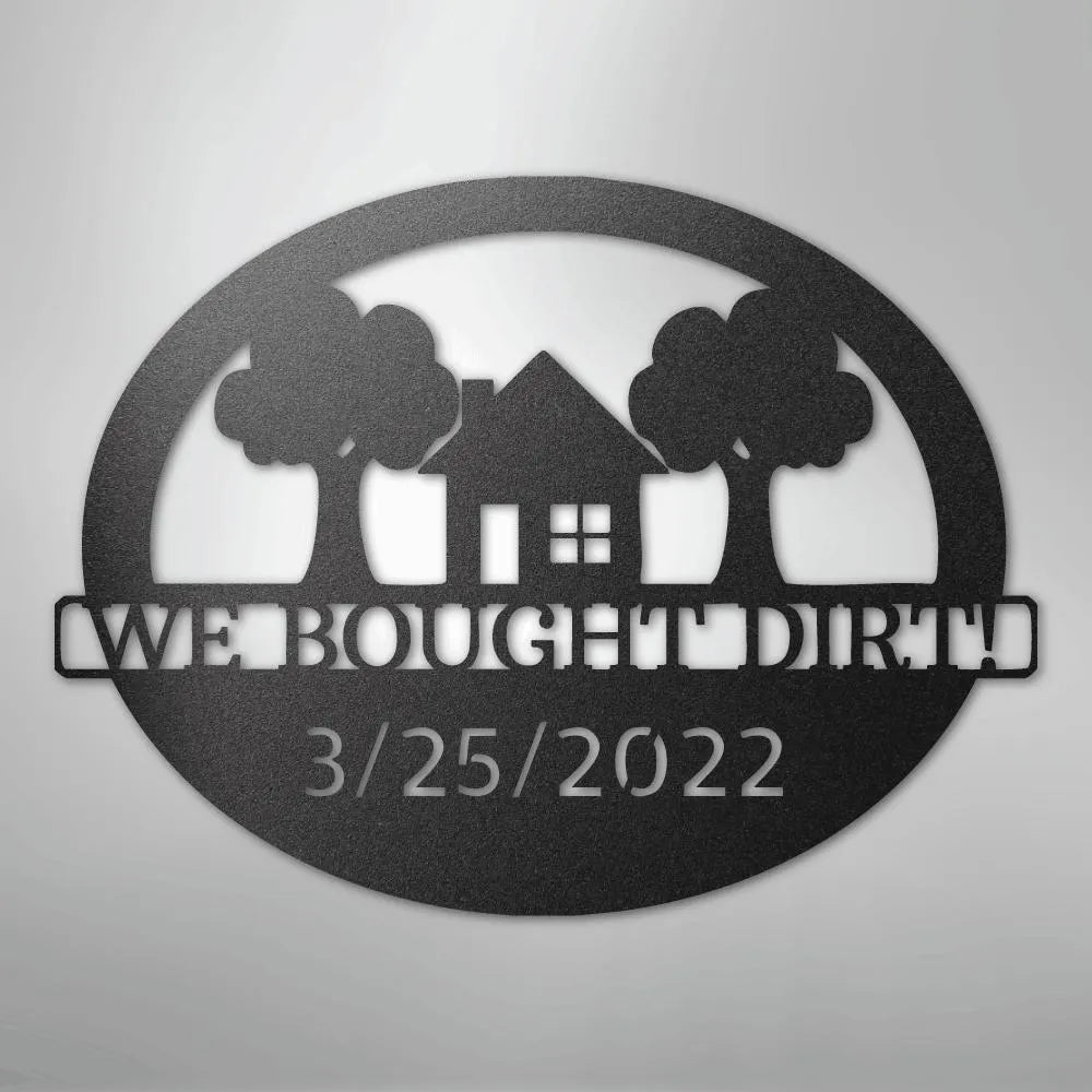 Black metal oval wall art with "WE BOUGHT DIRT!" and "3/25/2022" text, house, and trees.