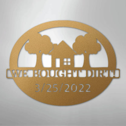 Bronze oval metal wall art with a house, two trees, "WE BOUGHT DIRT", and "3/25/2022" cut out.