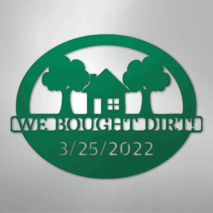 Green metal wall art with "WE BOUGHT DIRT!" and "3/25/2022" text, featuring a house and two trees.