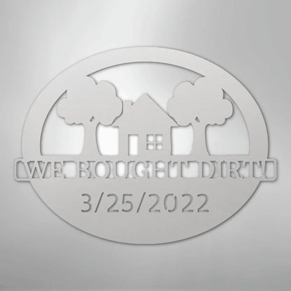 Silver metal wall art: "WE BOUGHT DIRT" with a house, trees, and "3/25/2022" in an oval design.