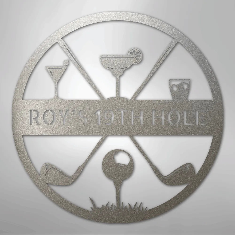 Silver metal "ROY'S 19TH HOLE" monogram sign with golf clubs, ball, and cocktail glasses.