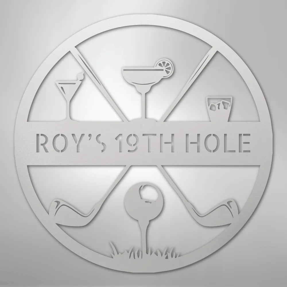 Silver metal "ROY'S 19TH HOLE" monogram sign with golf clubs, ball, and cocktail glasses.