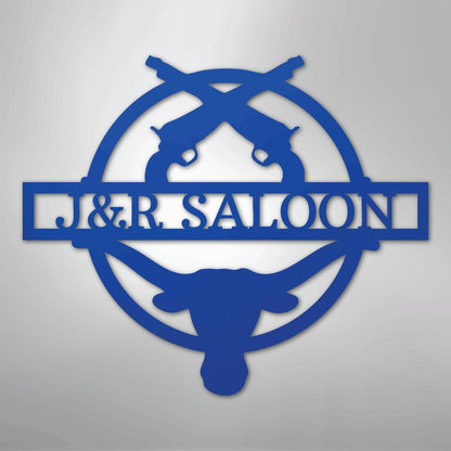 Blue metal "J&R Saloon" monogram with crossed pistols and a longhorn skull design.