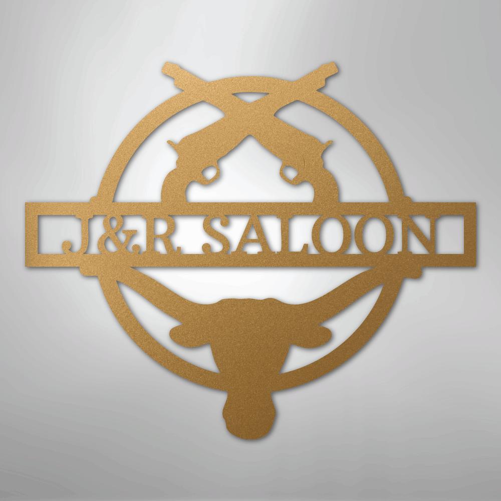 Gold metal "J&R Saloon" monogram wall art with crossed pistols and bull skull design.