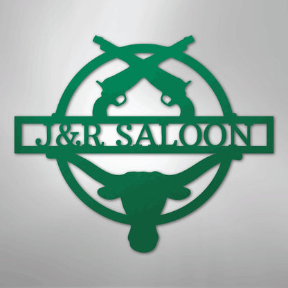 Green metal "J&R Saloon" monogram with crossed pistols and a longhorn skull design.