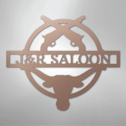 Bronze metal "J&R SALOON" monogram with crossed pistols and longhorn skull design.