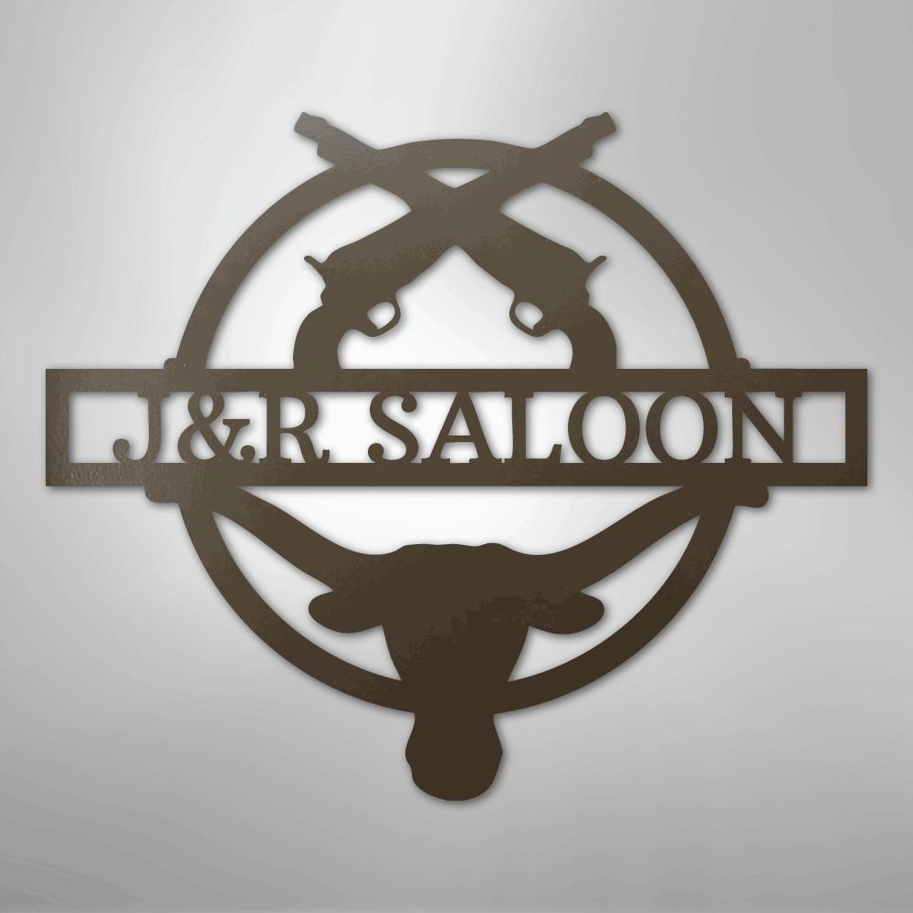 Brown metal "J&R SALOON" monogram with crossed pistols and a longhorn skull, suitable for indoor/outdoor decor.