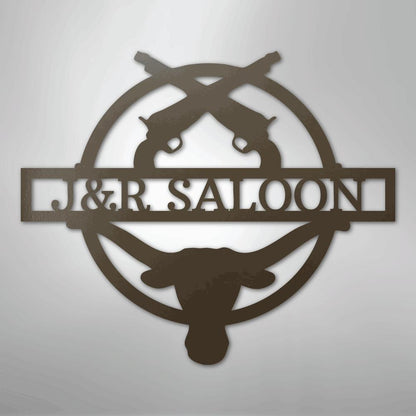 Brown metal "J&R SALOON" monogram with crossed pistols and a longhorn skull, suitable for indoor/outdoor decor.