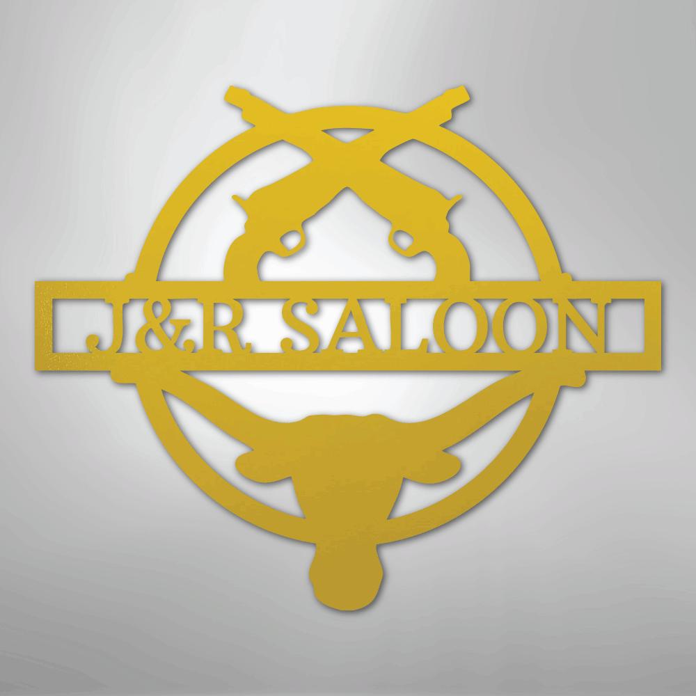 Gold metal "J&R Saloon" monogram with crossed pistols and a longhorn skull design.