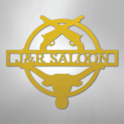Gold metal "J&R Saloon" monogram with crossed pistols and a longhorn skull design.