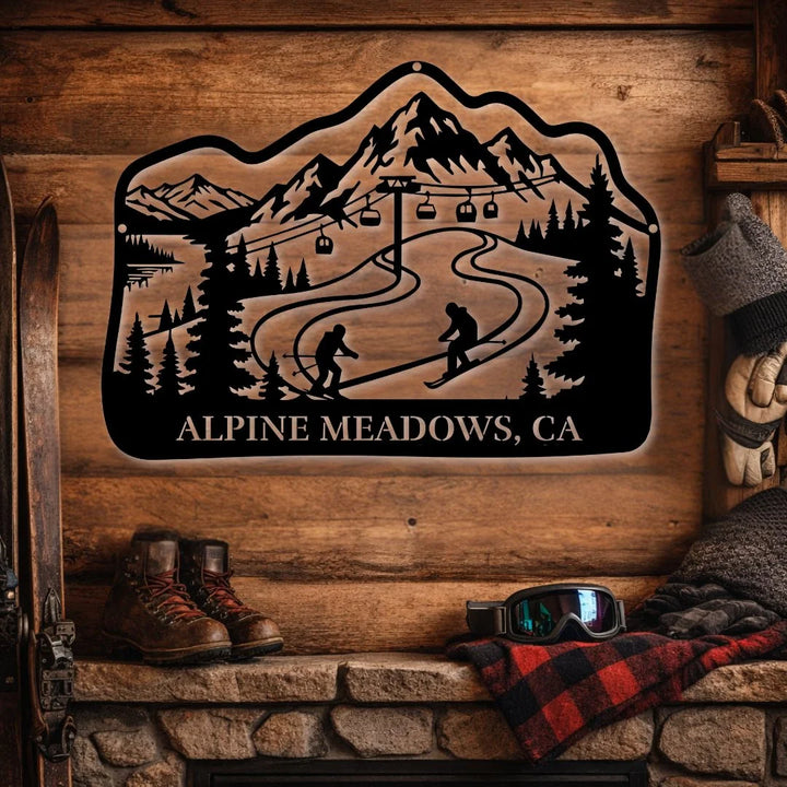 Decorative metal sign with mountain and ski lift design on a wooden wall, featuring 'Alpine Meadows, CA'.