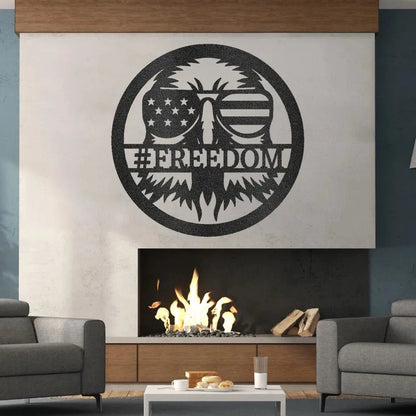 Black metal "FREEDOM" sign featuring an eagle wearing American flag sunglasses, mounted above a modern fireplace.