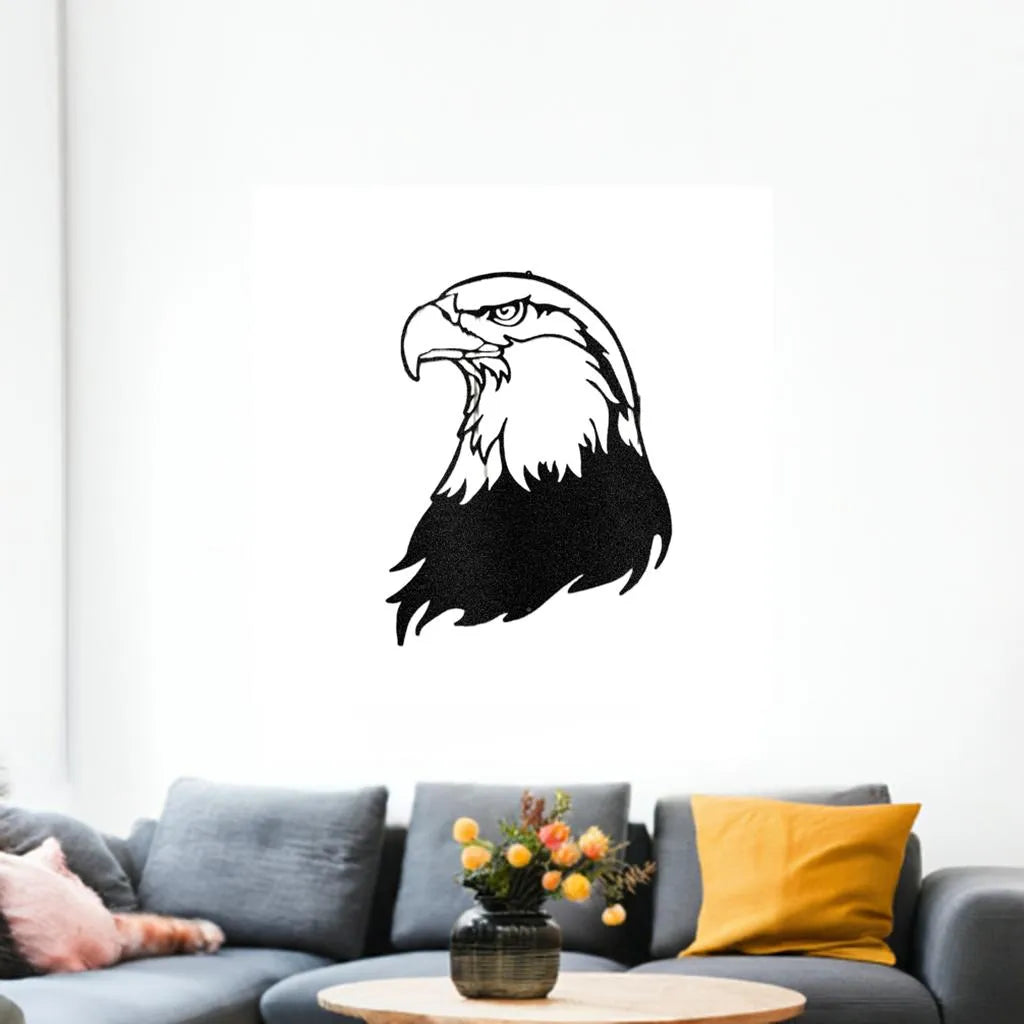 Black metal bald eagle head wall art, a detailed silhouette design hanging above a gray sofa.