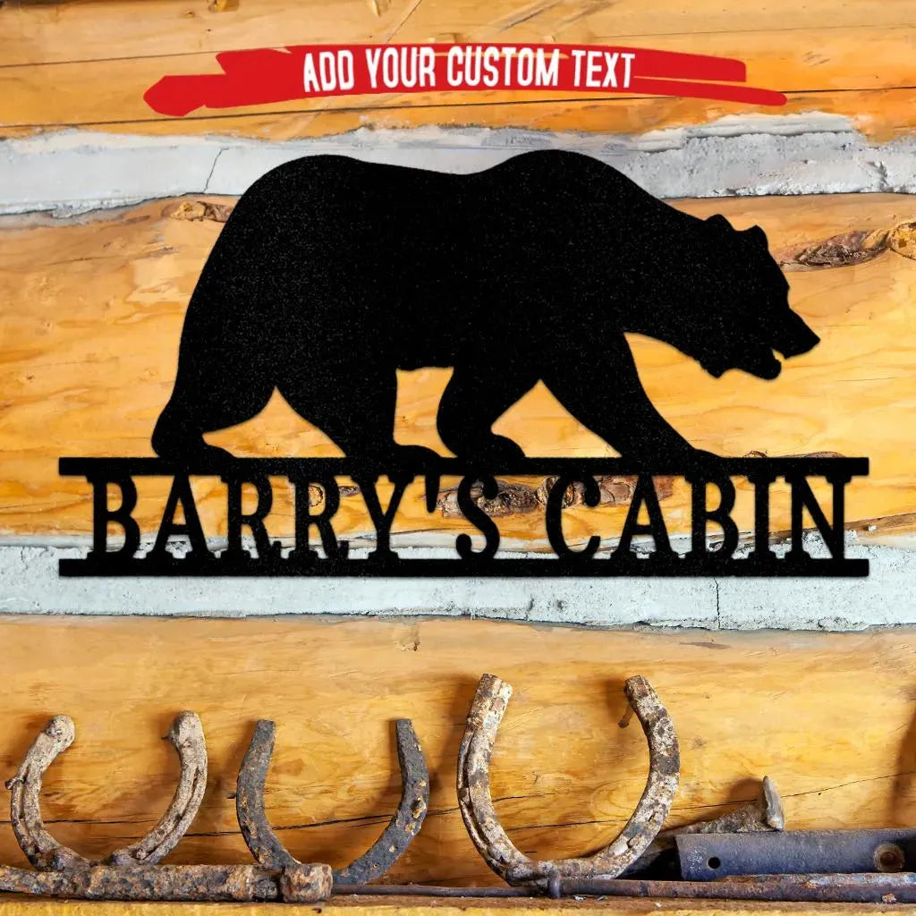 Black metal bear monogram wall art with "BARRY'S CABIN" custom text, mounted on a rustic wood wall.