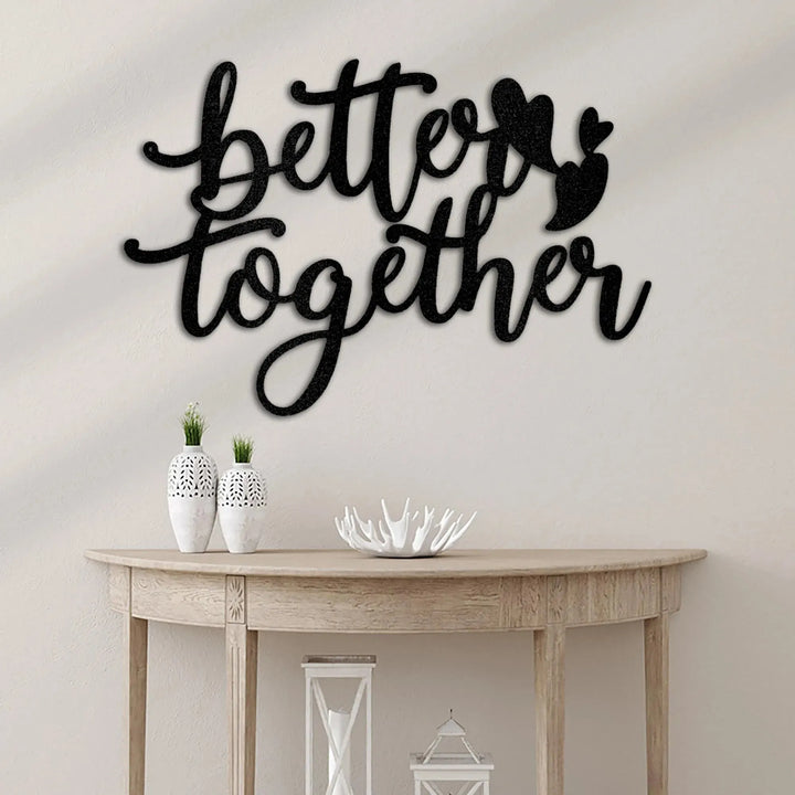Black metal "Better Together" wall art with hearts, displayed above a wooden console table.