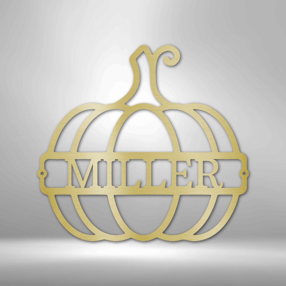 Gold metal pumpkin wall art with "MILLER" cut out in the center.