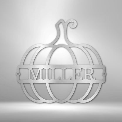 Silver metal pumpkin wall art with "MILLER" cutout in the center.