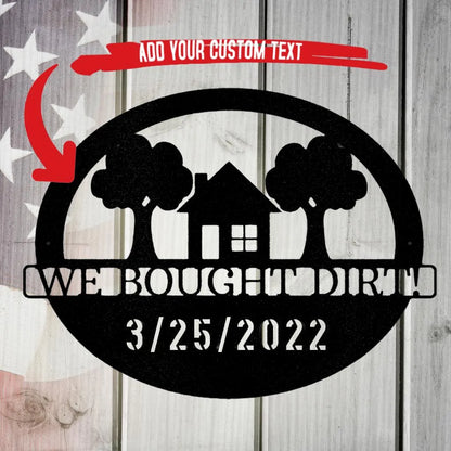 Black metal oval wall art with a house, trees, and "WE BOUGHT DIRT! 3/25/2022" text.
