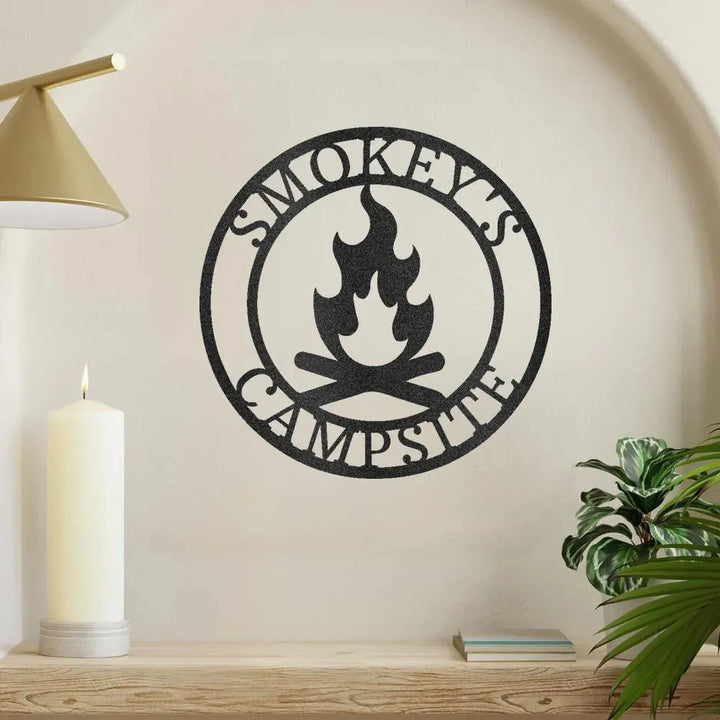 Black metal campfire monogram wall art with "Smokey's Campsite" text and flame design.