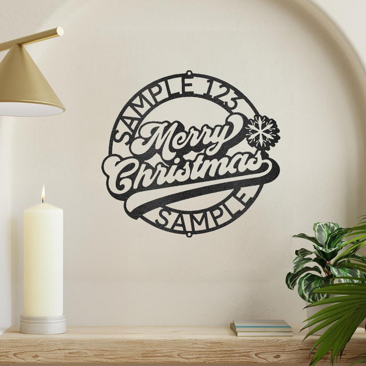Black metal Christmas Ring wall art with "Merry Christmas" and snowflake design.