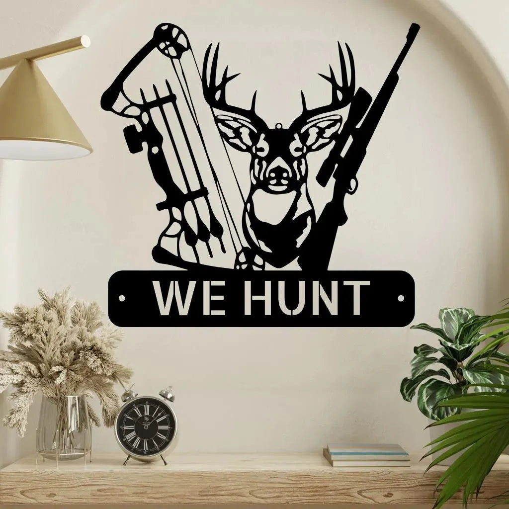 Black metal deer hunter monogram wall art featuring a deer head, bow, rifle, and "WE HUNT" text.